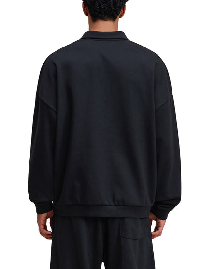 Person wearing a black tracksuit on a white background